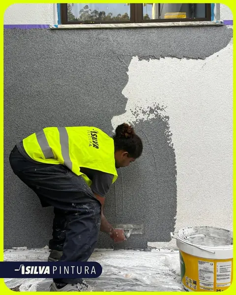 Profissional da SILVA Pintura a aplicar revestimento em fachada